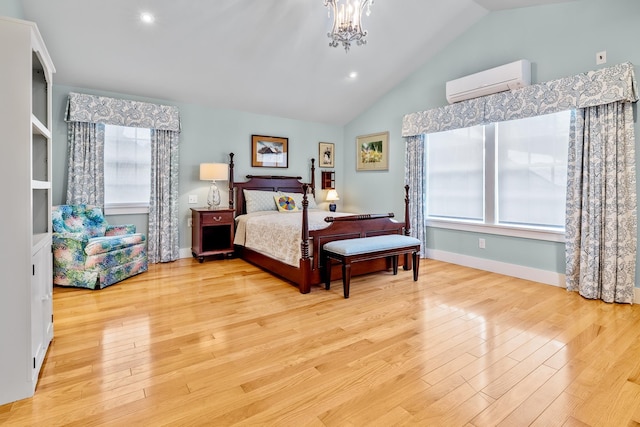 bedroom with high vaulted ceiling, a chandelier, a wall mounted AC, and light wood-type flooring