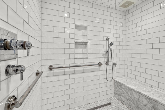 bathroom with a tile shower