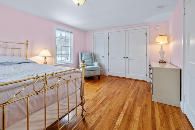 bedroom with a closet and light hardwood / wood-style flooring