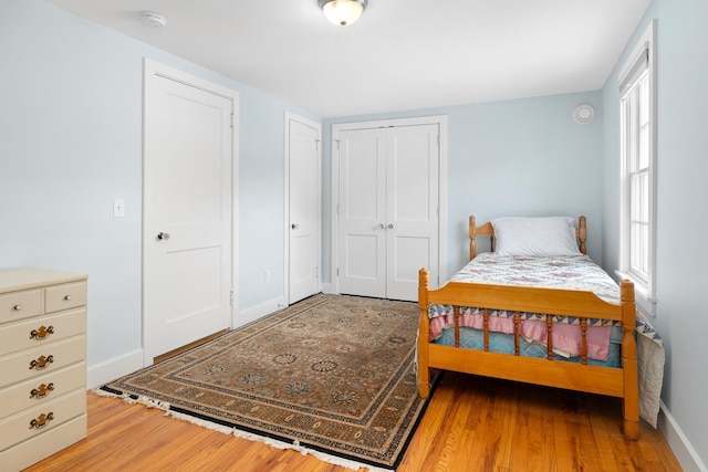 bedroom with wood-type flooring