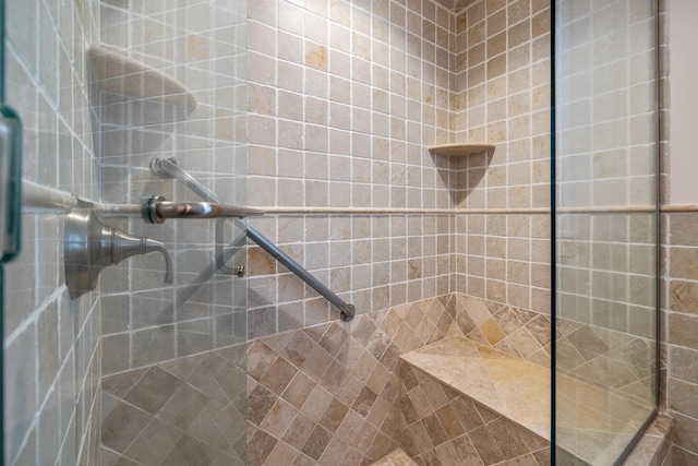 bathroom with tiled shower