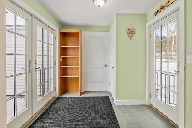 doorway featuring light tile patterned floors and french doors