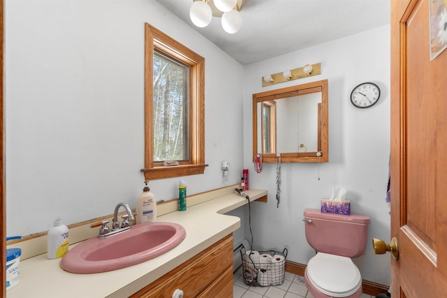 bathroom with tile patterned flooring, vanity, and toilet