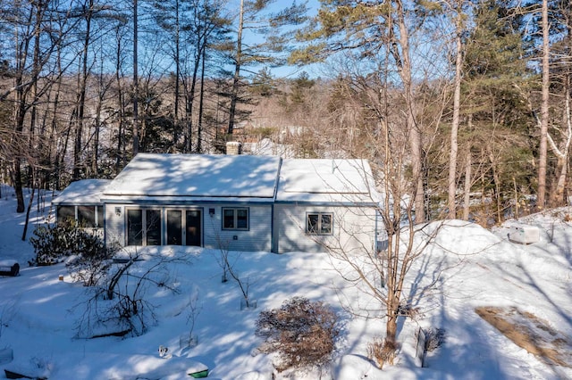 view of snow covered rear of property