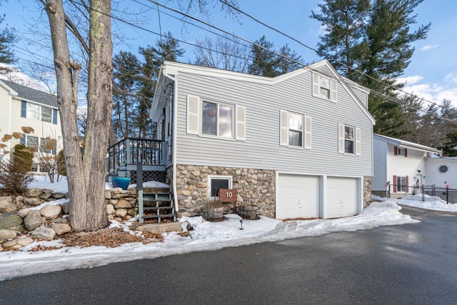 snow covered property featuring a garage