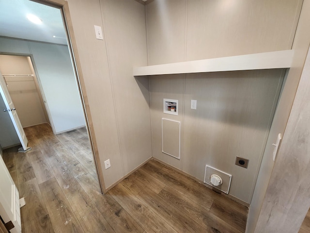 washroom featuring hookup for a washing machine, light hardwood / wood-style flooring, and hookup for an electric dryer