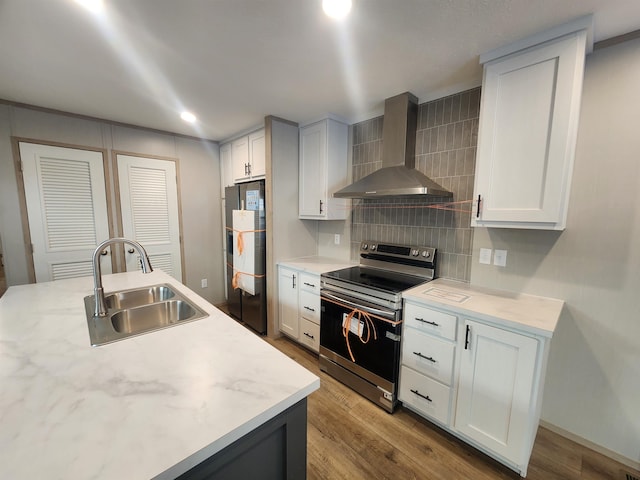 kitchen featuring white cabinetry, electric range, sink, and wall chimney range hood