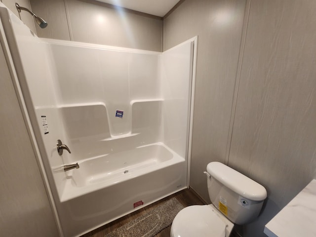 bathroom featuring toilet, bathing tub / shower combination, and hardwood / wood-style floors