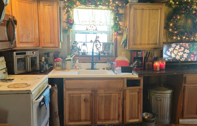 kitchen featuring sink and electric range