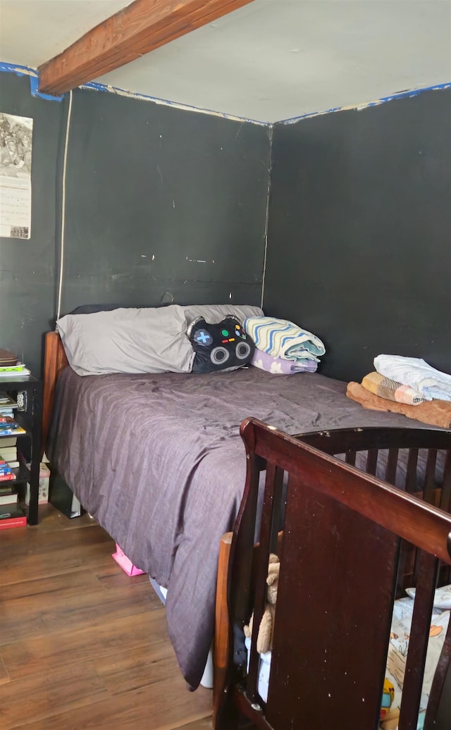 bedroom with hardwood / wood-style flooring and beam ceiling