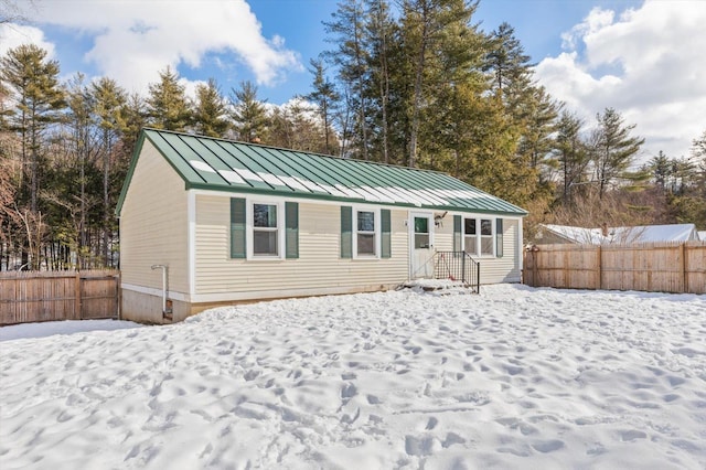 view of snow covered back of property