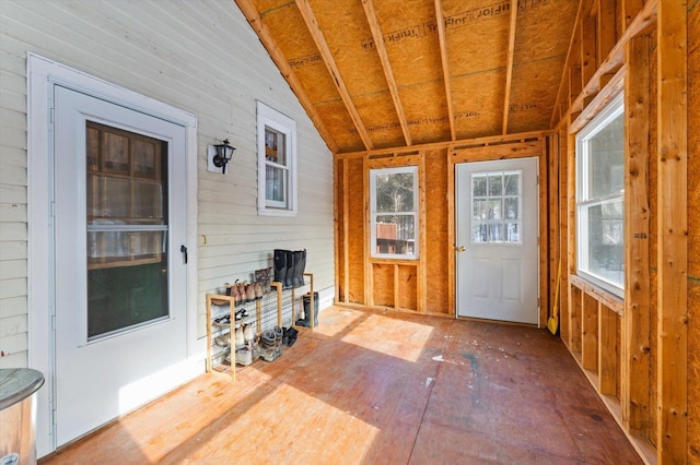 unfurnished sunroom featuring lofted ceiling