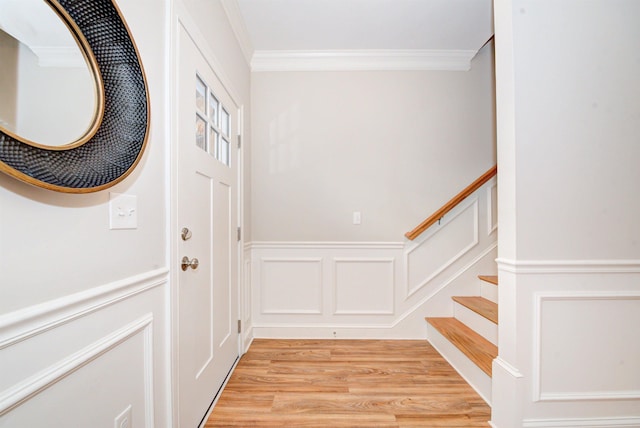 doorway to outside with crown molding and light wood-type flooring