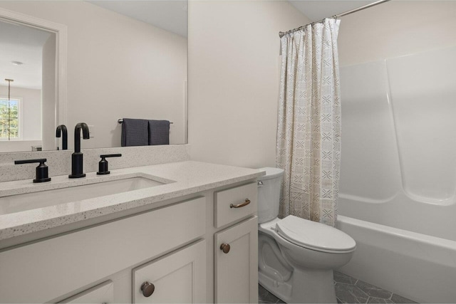 full bathroom with vanity, shower / tub combo, and toilet