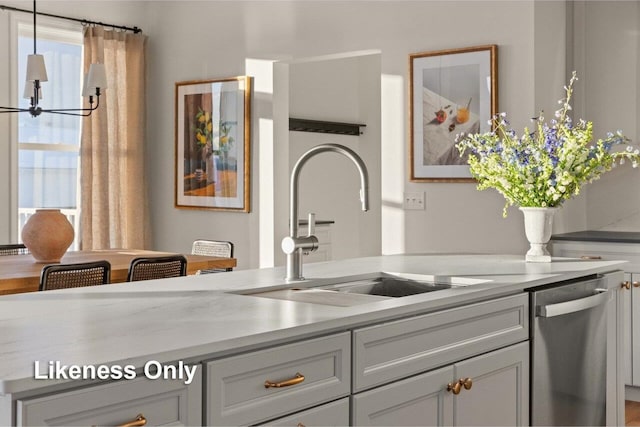 kitchen featuring gray cabinets, dishwasher, sink, and hanging light fixtures