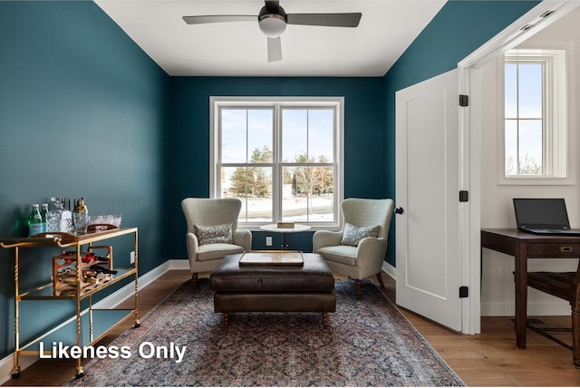 sitting room with hardwood / wood-style flooring and ceiling fan