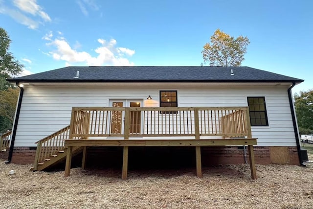 rear view of house with crawl space, a wooden deck, stairs, and a shingled roof