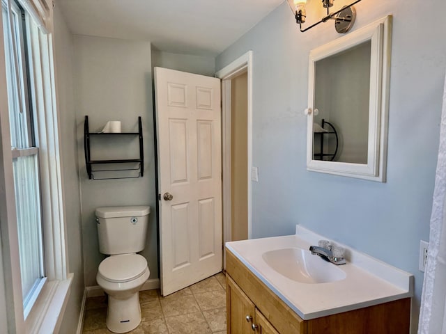 bathroom featuring vanity, toilet, and tile patterned flooring