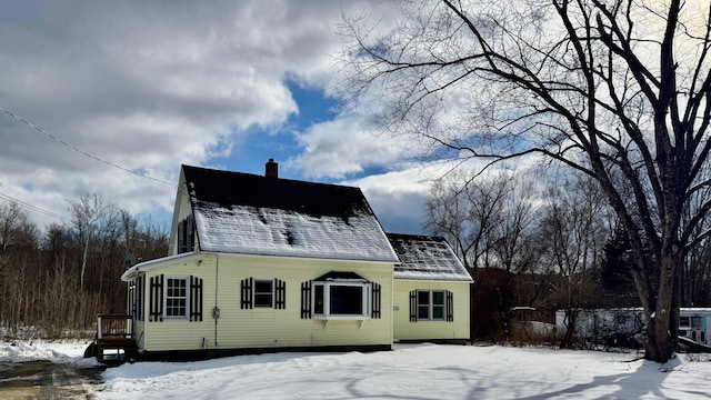 view of snow covered back of property