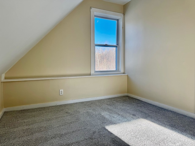 bonus room featuring lofted ceiling and carpet flooring