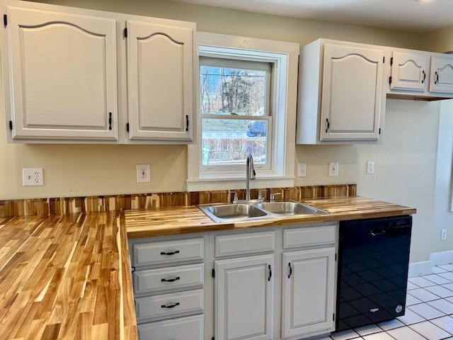 kitchen with light tile patterned flooring, sink, white cabinetry, wooden counters, and dishwasher