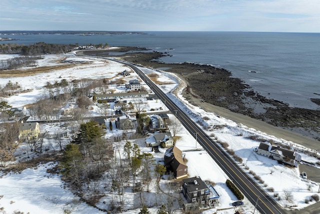 snowy aerial view with a water view