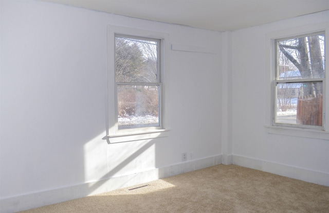 empty room featuring carpet and visible vents