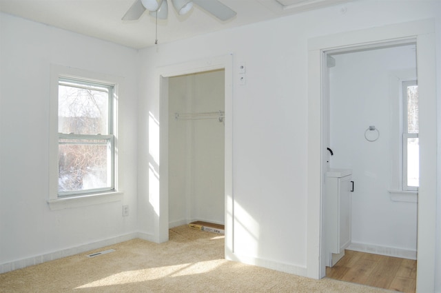 interior space featuring light colored carpet, visible vents, and baseboards