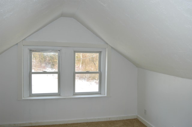 bonus room with lofted ceiling, carpet floors, a wealth of natural light, and baseboards