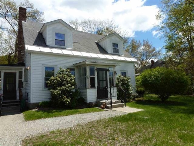 new england style home featuring a front lawn