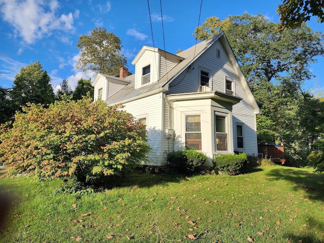 view of property exterior with a lawn