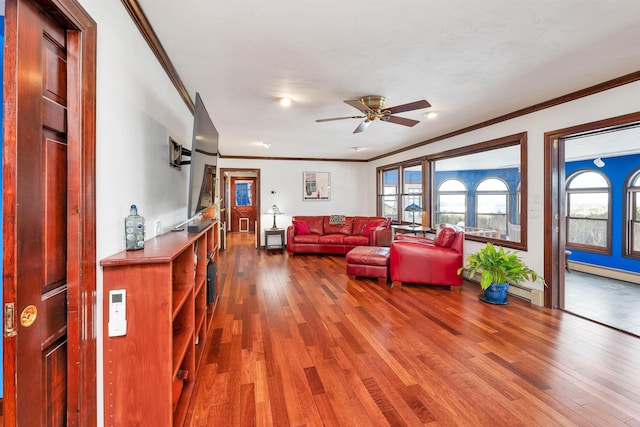 living room with ceiling fan, crown molding, wood-type flooring, and a baseboard heating unit