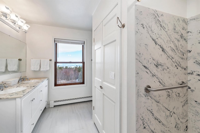 bathroom with vanity and a baseboard heating unit