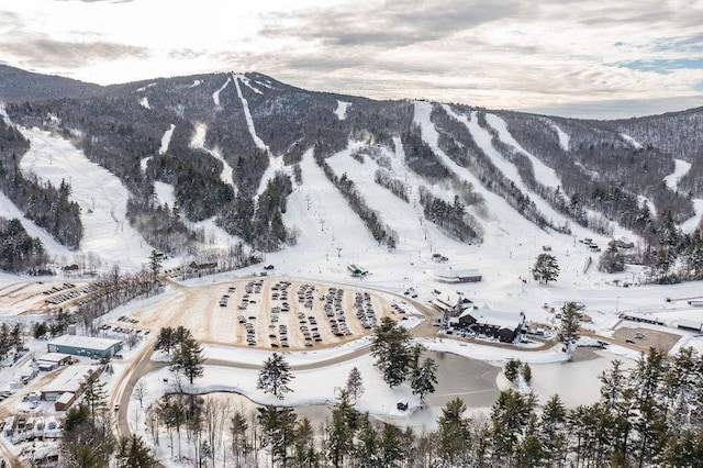 snowy aerial view featuring a mountain view