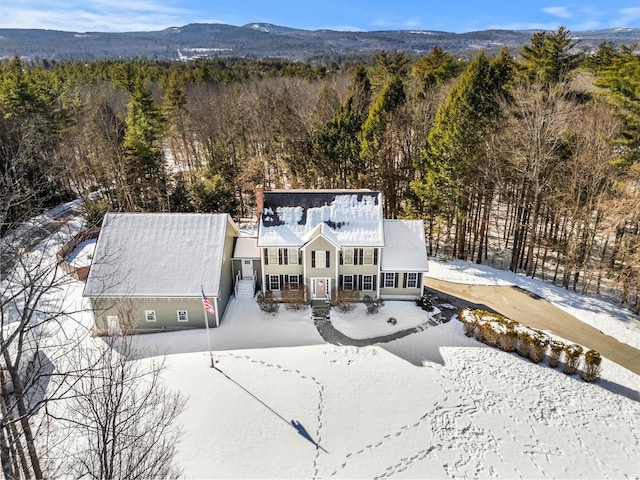 snowy aerial view with a mountain view