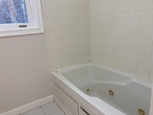 bathroom with a washtub and tile patterned floors