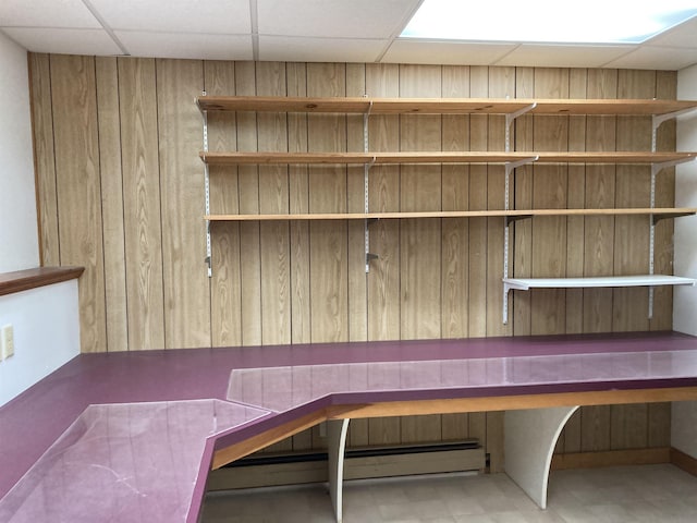 unfurnished office with a paneled ceiling and baseboard heating