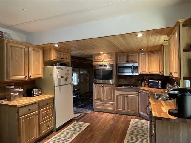 kitchen with wood counters, sink, wood ceiling, appliances with stainless steel finishes, and dark hardwood / wood-style flooring