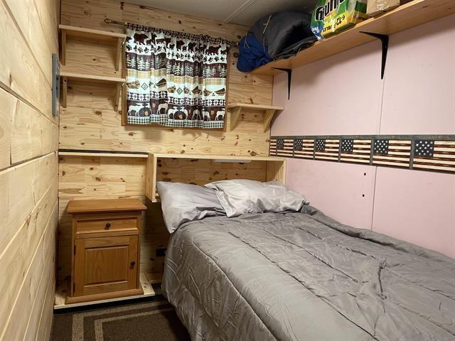 bedroom with wooden walls