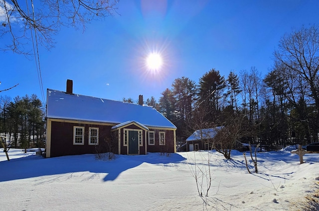 view of snow covered rear of property