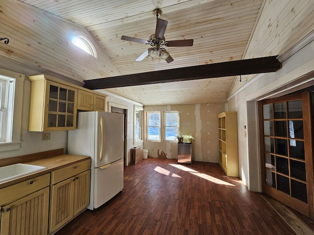 kitchen with vaulted ceiling with beams, sink, dark hardwood / wood-style flooring, white refrigerator, and ceiling fan