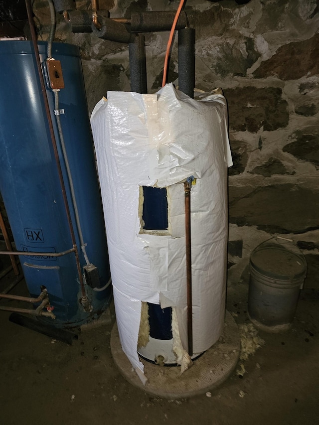 utility room featuring water heater