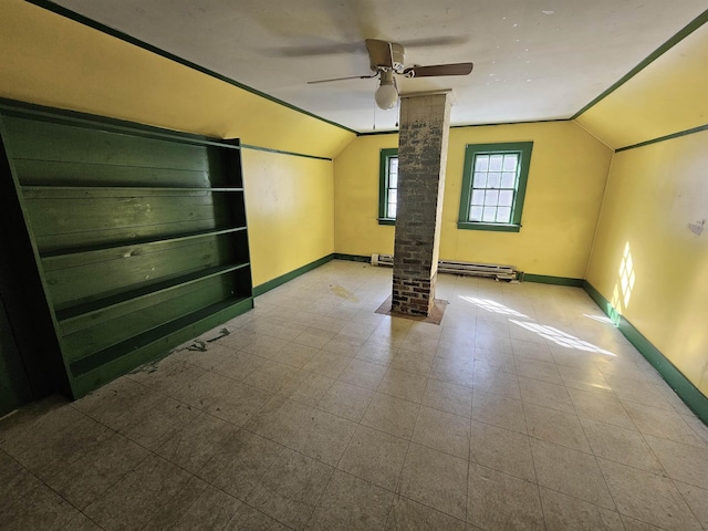 spare room with lofted ceiling, a baseboard radiator, ceiling fan, and ornate columns