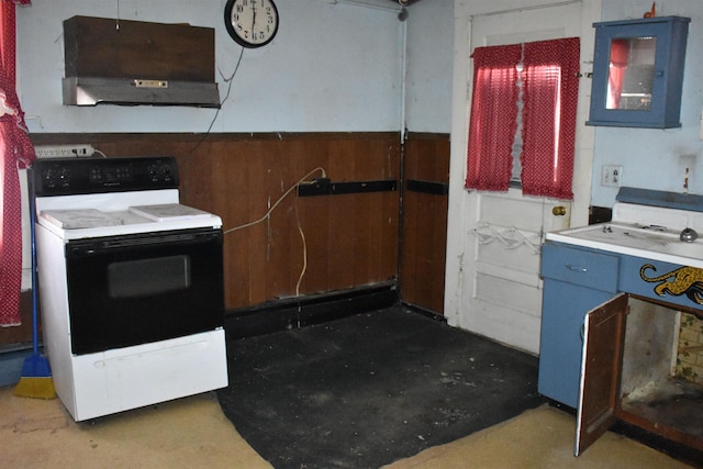 kitchen featuring blue cabinets, range with electric cooktop, wall chimney range hood, and wooden walls