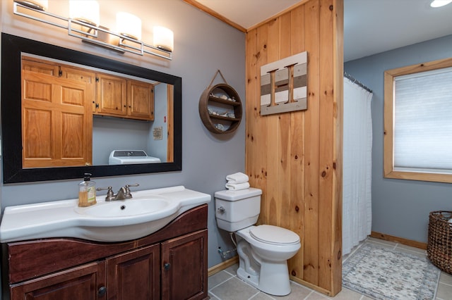 bathroom featuring washer / clothes dryer, vanity, tile patterned floors, and toilet