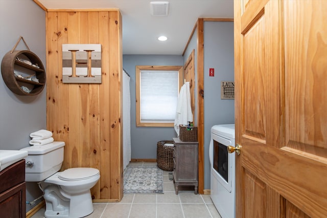 bathroom with tile patterned flooring, vanity, washer / dryer, and toilet