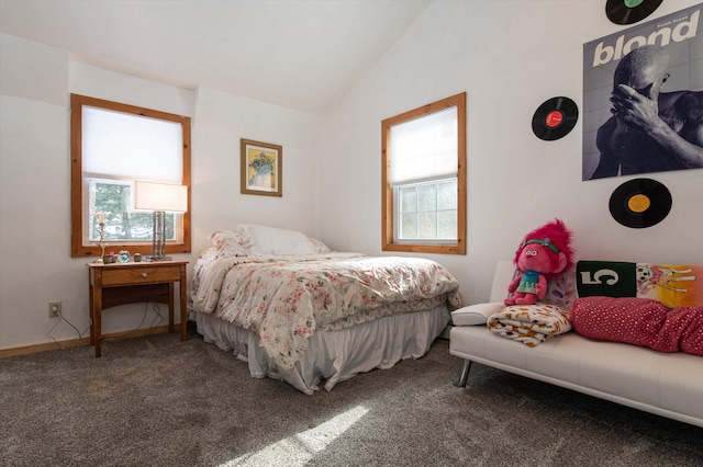 bedroom with carpet floors, vaulted ceiling, and multiple windows