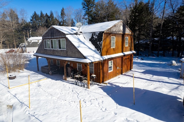 view of snow covered back of property