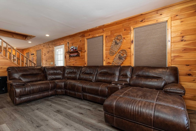 living room featuring wood-type flooring and wooden walls