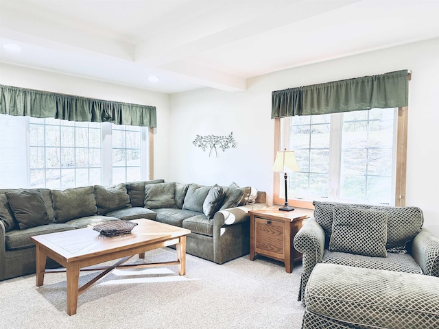 carpeted living room featuring beam ceiling